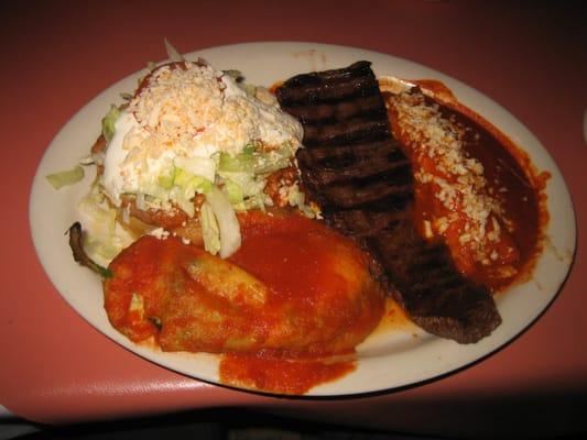 Fiesta lunch combination - chile relleno, skirt steak, enchilada, and a pork sope/gordita