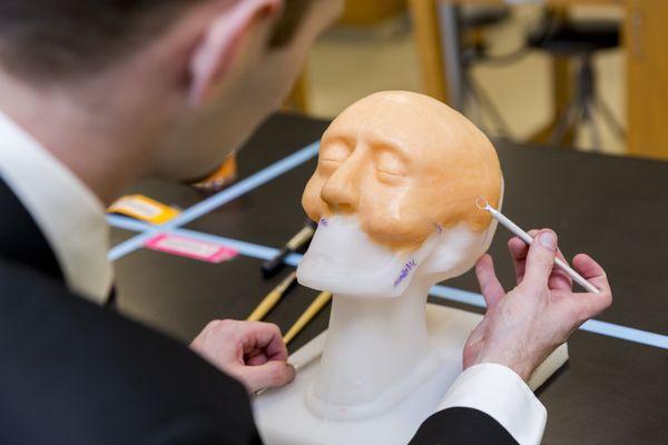 Student Christopher Ellis works on his wax head