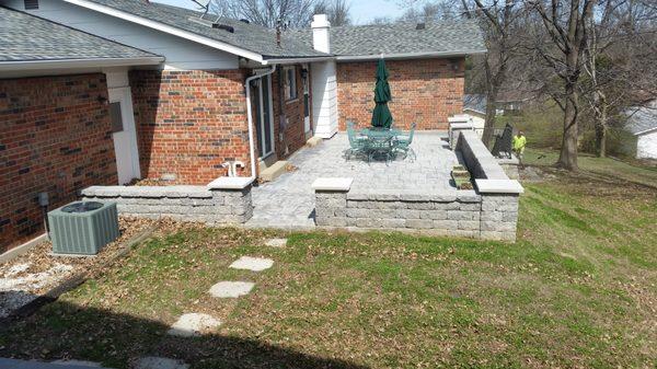 We installed the retaining wall & the stamped concrete patio.