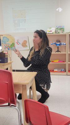 Miss Paola reading to our friends at our Read Across America event.