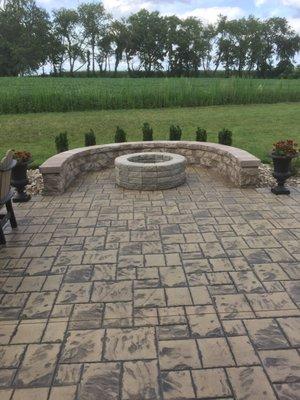 Ashlar Slate patio with fire ring and seat wall. Hot dogs and s'mores anyone?