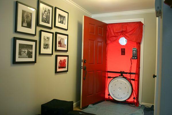 Complete setup of the blower door system getting ready to test air leakage of the home