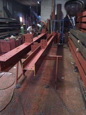 Preparing and fabricating steel beams for a new building project ground up as followed on plan