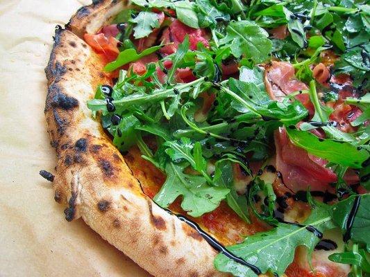 Prosciutto and fresh ricotta pie topped with arugula salad