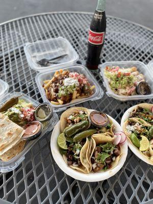 Quesadilla supreme, fries de pastor, chicken flautas, tacos de lengua and asada with red and green salsa