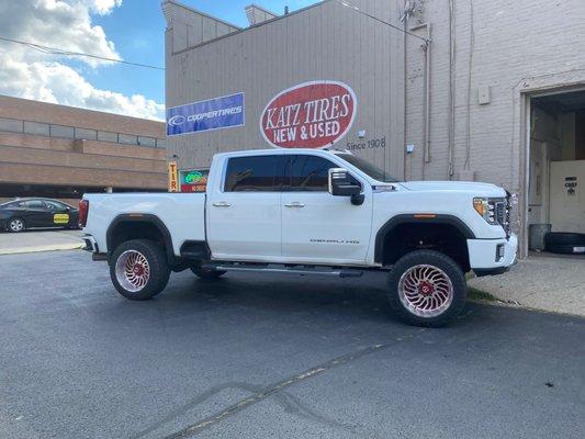 Chrome with red 22inch wheels on a new lifted Denali gmc