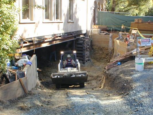 Excavating under an existing structure that is shored for the purposes of adding a basement.