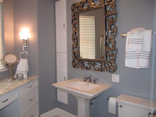 An antique framed mirror adds interest in this master bathroom.