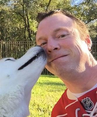 Computer expert who loves dogs. Here he is with one of his gentle, beloved Huskies.