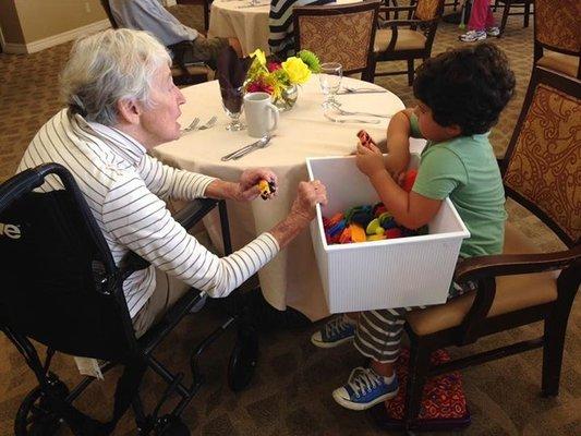 Owner's son engaging with residents at a local memory care community.