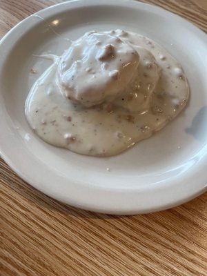 Very small; grill cooked frozen biscuit, not fresh or good, bland gravy.