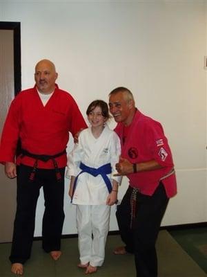 Senior Grand Master Rick Alemany and Sensei Mark Cameron Congratulate Elizabeth Russell on a great job.