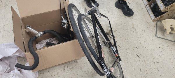 Bicycle fully disassembled and put in a box