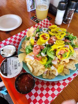 Sad nachos with vacuum sealed guacamole add-on and jarred salsa.