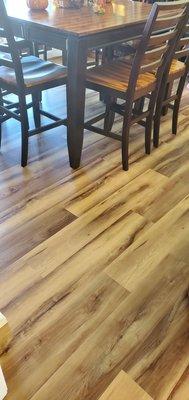 Shot of new waterproof flooring into dining room.