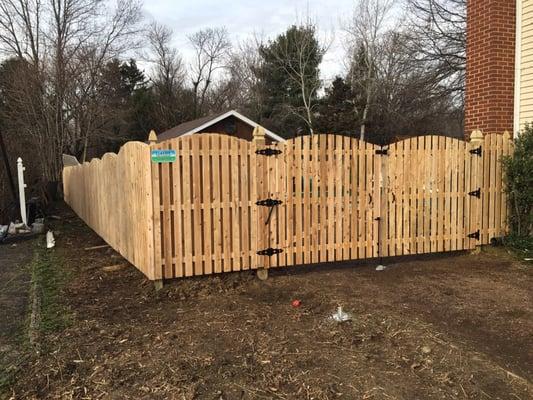 Pool code shadow board wood fence including a 12' wide double gate and 6" gothic topped gate posts.