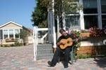 Resident playing guitar on Pat Moore Foundation's friendly and welcoming campus