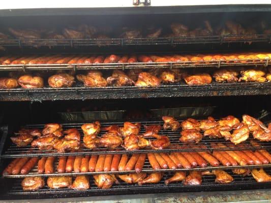 Rotisserie pit full of Chickens and Sausage