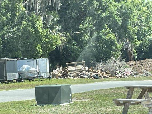 There is a giant trash pile in view of many campers...