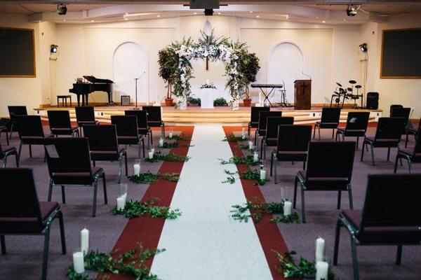 Flower arch with candles and greenery