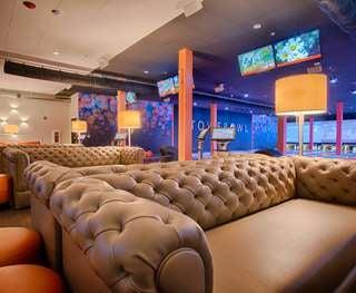 Plush leather couches allow for bowling in comfort.