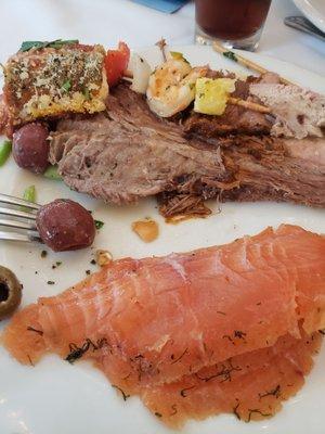 Cured salmon (gravlax), beef brisket, shrimp skewer, eggplant rollatini, remnants of seafood (seafud) salad.