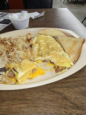 Cheese and sausage omelet, hash browns, and toast.