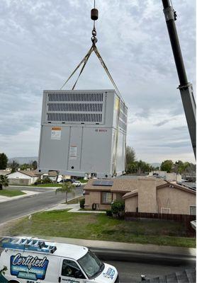 Crane lift new Heat-pump roof top unit set with new roof curb.