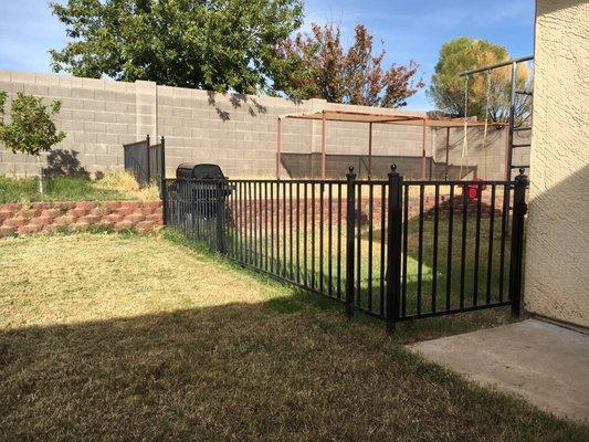 Fence with gate and ball caps. This fence is 3 foot tall and steps up to connect to block wall.