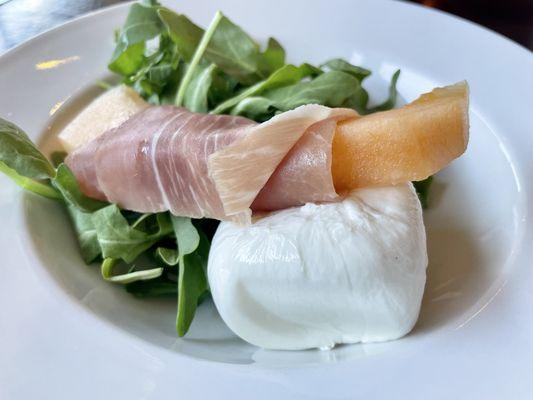 Prosciutto wrapped cantaloupe & fresh burrata over organic arugula.