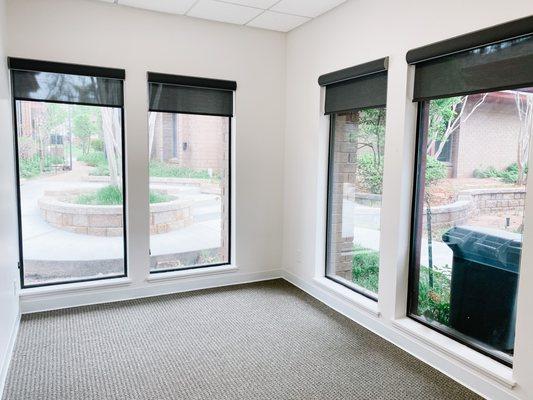 Private offices overlooking a scenic courtyard.