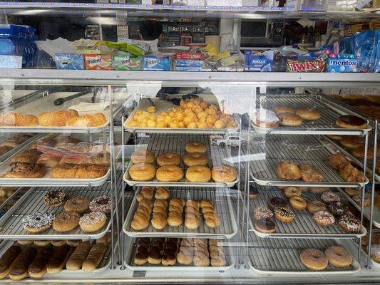 Donuts in the display case waiting to find a good home in someone's belly.