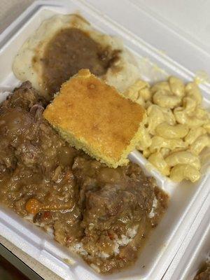 Here is Oxtails, mashed potatoes, with Mac and cheese and cornbread.