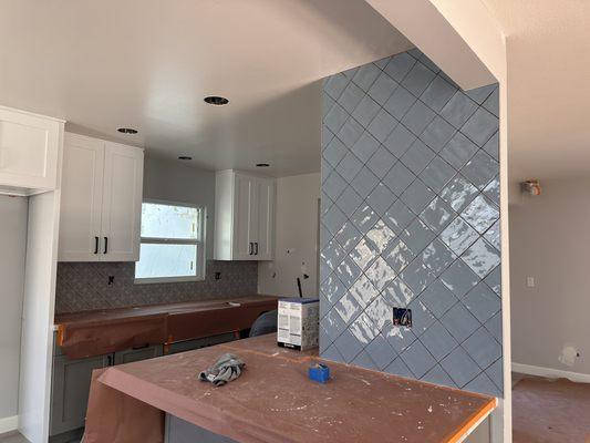 Solid blue tile over the breakfast bar