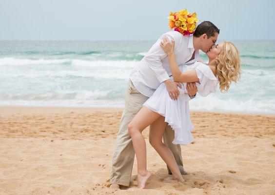 Romantic elopement wedding on the beach with bride wearing a short wedding dress from Westwood wedding photographer.