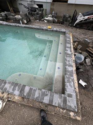 Pool Coping Done in a Slate Paver With White Grout.