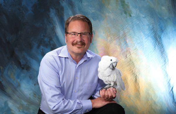 Dr. Freeman and Dusty the Umbrella Cockatoo that has been part of the Freeman Family for more than 30 years