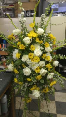 Striking yellow and white sympathy spray.