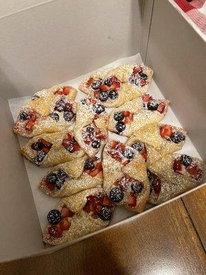 Fresh berry pastelitos with strawberries, blueberries and sweetened cream cheese.