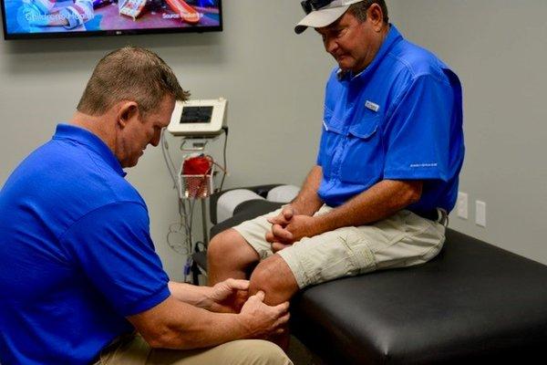 Philip, our Nurse Practitioner, evaluating a patient for regenerative treatments.