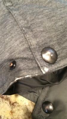 This is one of the many holes left in my husband's $400 polo coat. The owner says they were there when I brought it in & won't even refund.