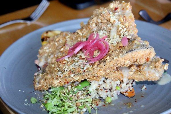 The Crispy Trout Almandine was made with almond crusted trout, carrots, snap peas, quinoa, toasted garlic chile oil, pickled red onions, beu