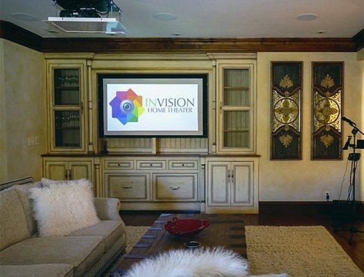 Projector and screen custom mounted inside custom built wood cabinet.