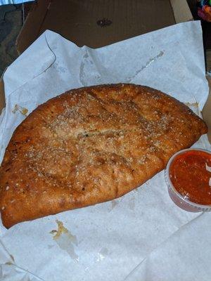 Calzone is HUGE! Sausage, pepperoni, onion and mushroom. Delicious!