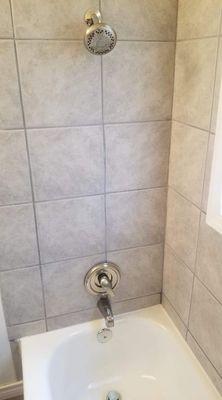 New shower/bathtub fixtures installed for a customer and the shower tiles and grouting cleaned up to look brand new.