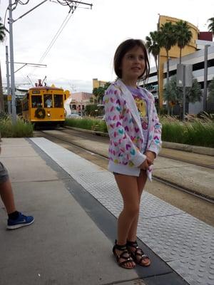 Some cute kid waiting for the streetcar.