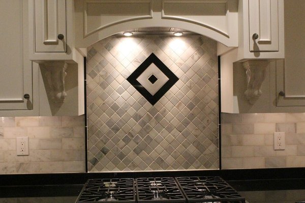 Custom Grecian marble and black granite backsplash