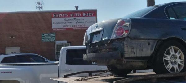 A car on the tow in front of Espo's Auto Body shop located in Copiague, NY. So come on over because we do that too!