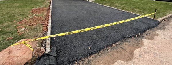 Uneven paving where the driveway meets the street. It's also way too high. It's breaking and falling apart now.