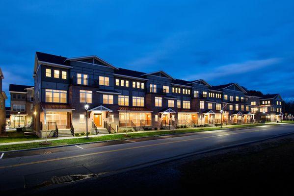 Exterior street view of The Lofts at Saratoga Blvd 3-story apartment buildings.